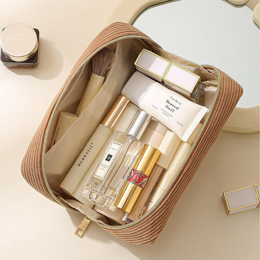 Cosmetic bag with skincare products on a light background