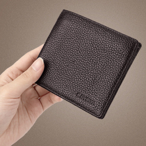 Hand holding a textured black wallet against a brown background with Chinese text.