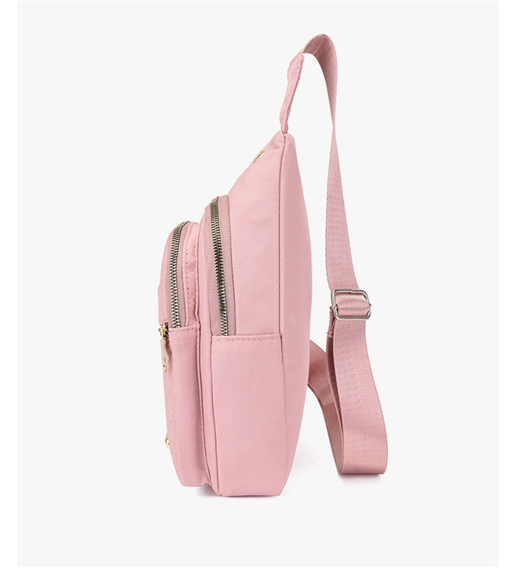 Pink backpack with a strap on a white background